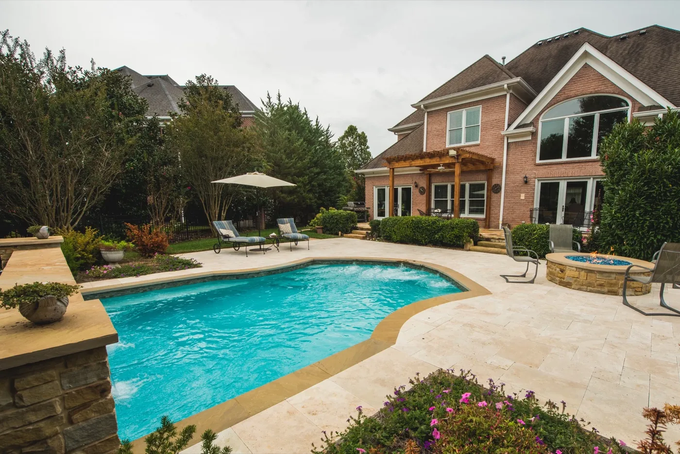 Francis Residence pool and backyard seen from the stone waterfall wall angle