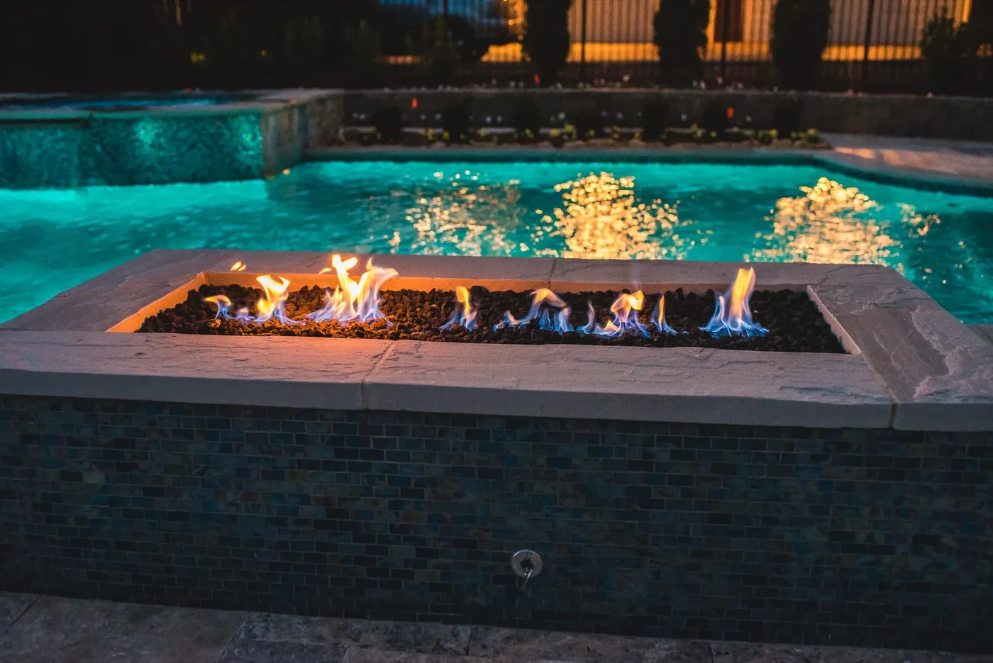 Illuminated resort-style pool and spa at Tarkington Residence built by Waterscapes in Middle Tennessee