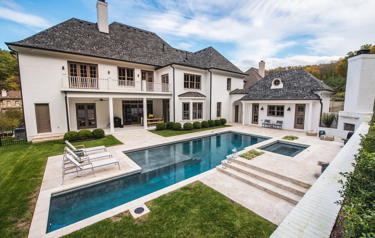 Clean modern rectangular gunite pool with attached spa and luxury estate in Nashville